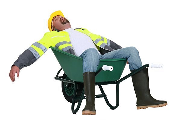 Tradesman asleep in a wheelbarrow